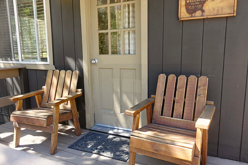 Pair of Adirondack chairs on the cabin’s front porch