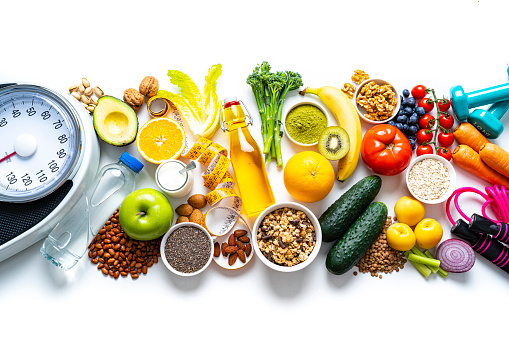 Assortment of healthy food with anti-inflammatory effect like vegetables, nuts, fruits and spices, light wooden background with copy space, selected soft focus, narrow depth of field