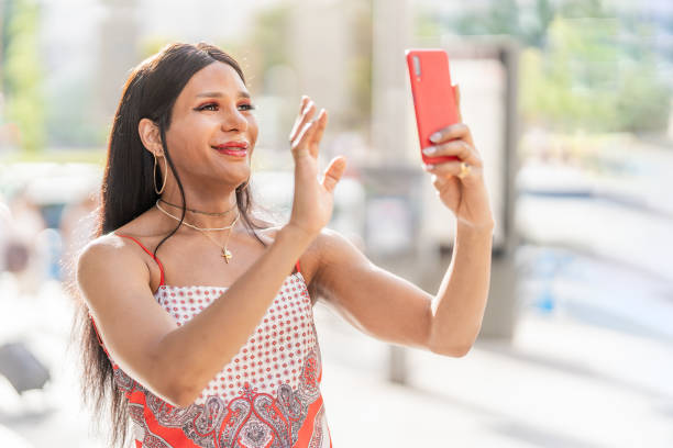 istock Trans woman waving at the mobile while doing video call 1421598923