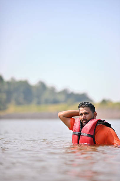 istock Young man swimming in lake water 1421600049