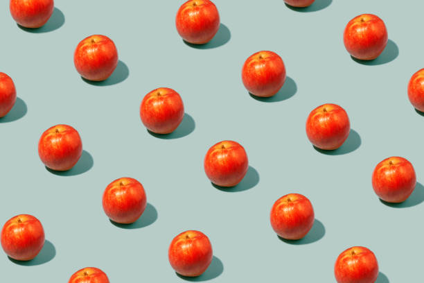 istock Red apples on a muted green background 1421601856