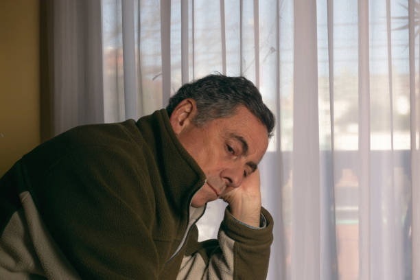 istock Man sitting alone at home 1421601908