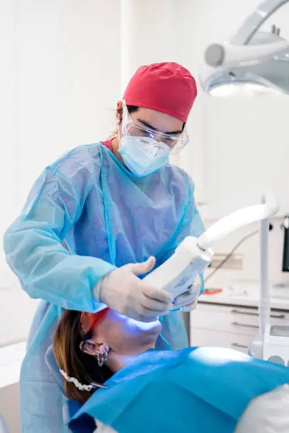 Photo of Woman Doing Tooth Whitening Treatment