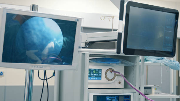 istock Operating room with patient vital signs monitors and laparoscopic equipment camera 1421604409