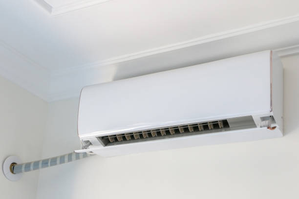 istock Air conditioner on white wall background, turned on, cooling down interior during heat wave and rising temperatures 1421605661