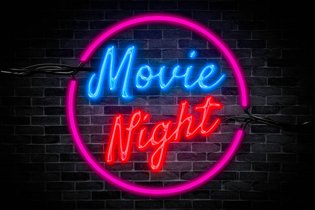 istock Movie night neon banner with pop corn sign on brick wall background. 1421606090