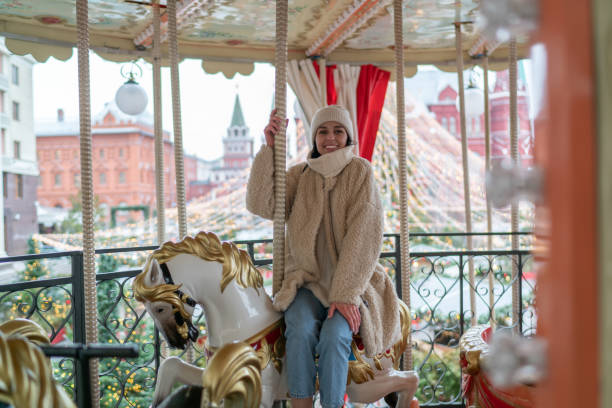 istock Content woman on carousel in park 1421612176