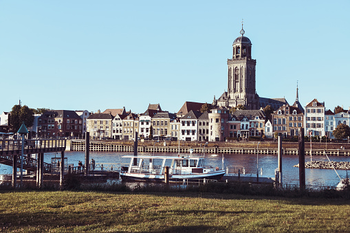 Grassland And Pier Of IJessel River Looking At St. Lebuinus Church In Deventer, The Netherlands