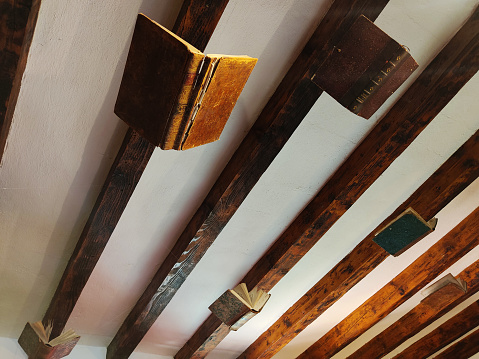 flying books on wooden ceiling