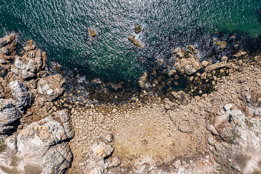 View from the drone on the wild coast of France, rocks and the ocean.