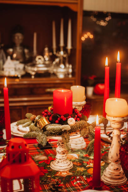 istock Christmas composition with a candle and fir branches on a festive table. 1421618015