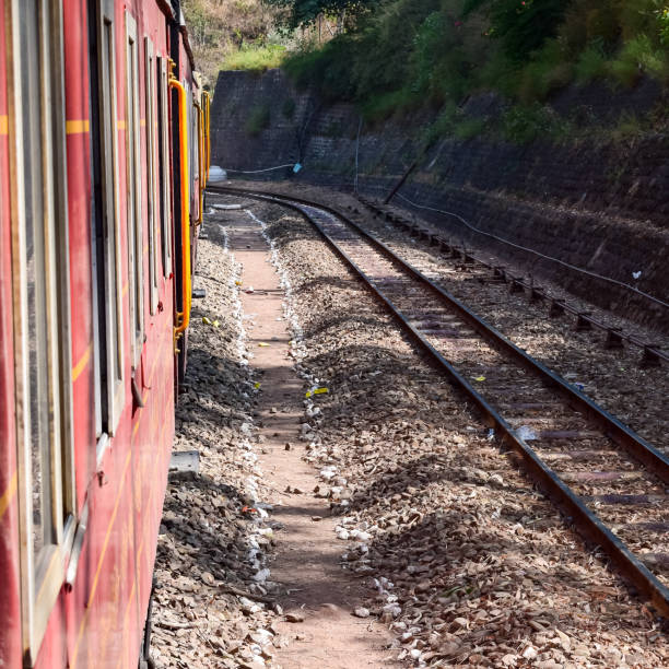 istock Toy Train moving on mountain slopes, beautiful view, one side mountain, one side valley moving on railway to the hill, among green natural forest. Toy train from Kalka to Shimla in India, Indian Train 1421618222