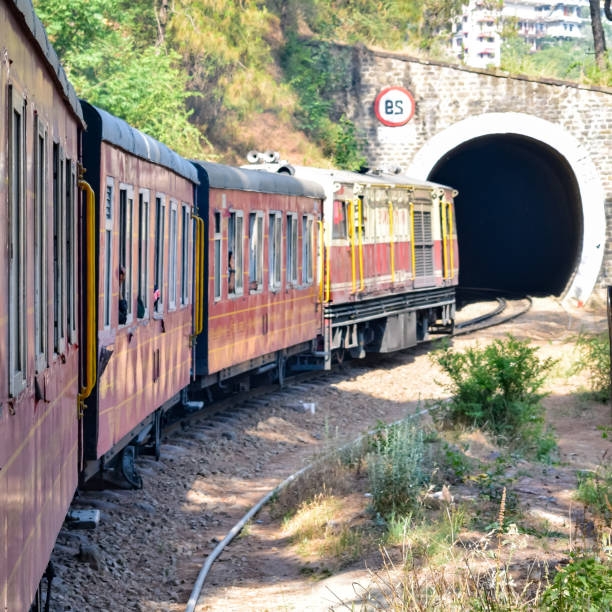 istock Toy Train moving on mountain slopes, beautiful view, one side mountain, one side valley moving on railway to the hill, among green natural forest. Toy train from Kalka to Shimla in India, Indian Train 1421618269