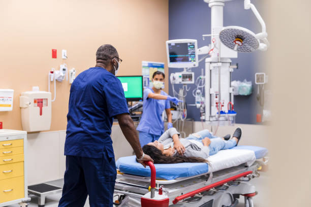 istock Nurse gives orderly directions when he wheels in patient 1421619881