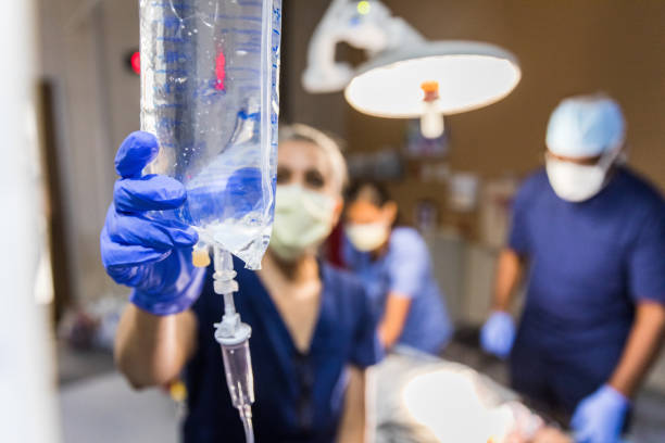 istock Focus on IV bag used for unrecognizable patient in background. 1421620122