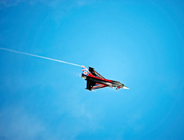 Eurofighter Typhoon, Bournemouth, England. The Eurofighter Typhoon is a European built multinational, twin-engine, canard delta wing,multirole fighter, seen here in flight over open sea with cumulus cloud formation in blue sky