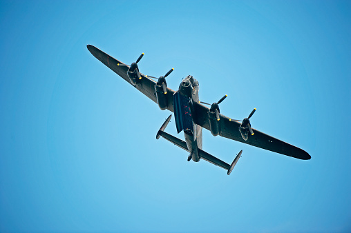 A classic Mk 1 Spitfire flies over the British countryside. Model photography.