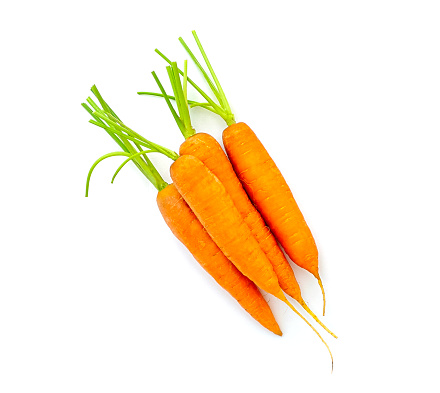 Four whole young carrots isolated on white, top view