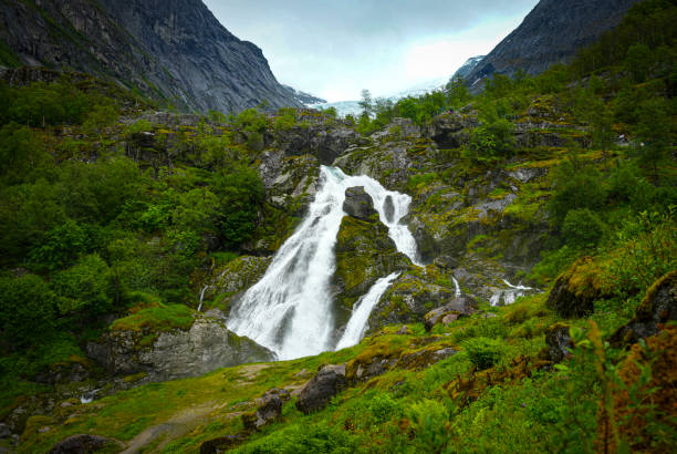 Waterfalls in the valley approaching Briksdal Glacier in Norway.
