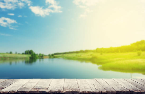 istock Wooden table with summer bokeh 1421624238