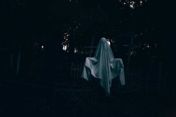 istock Levitating ghost in the cemetery between graves during Halloween 1421626014