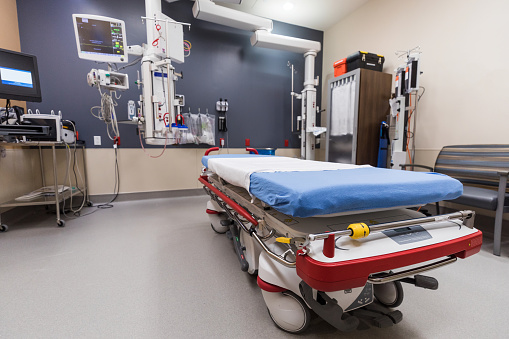 Color image of a hospital bed in the emergency room that is empty.