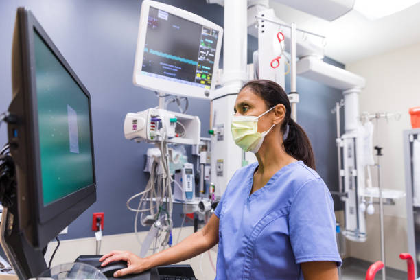 istock Nurse uses computer to review medical chart 1421626413