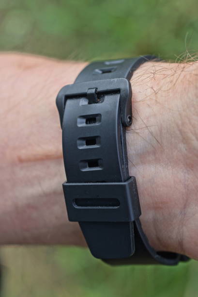 istock black closed plastic watch strap on a mans hand 1421630373