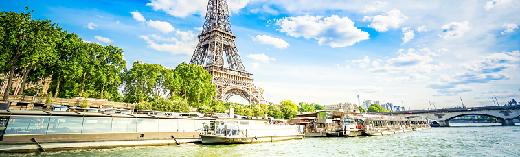Eiffel Tower and Seine riverbank at summer day, Paris, France with sunshine, web banner format