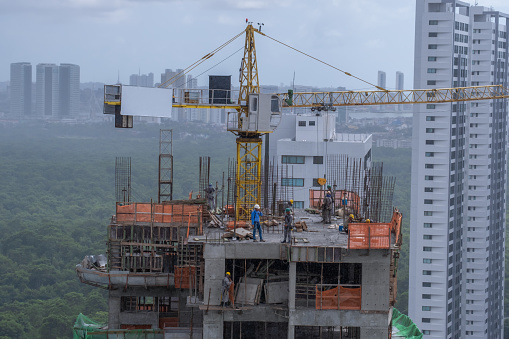 Recife, Pernambuco, Brazil - September 03, 2022:Brazilian men working on a building in Boa Viagem residential district.