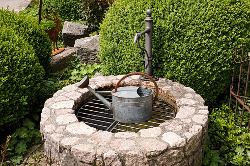 Old well with lever in a garden