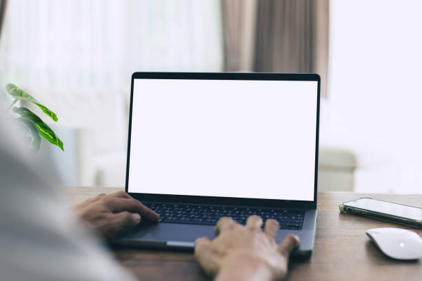 istock mock up businessman working empty screen computer on wood desk in home. Notebook Laptop with blank screen 1421634015