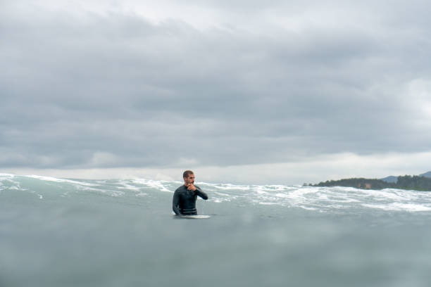 istock surfer waiting for a wave in the sea during a storm 1421634344