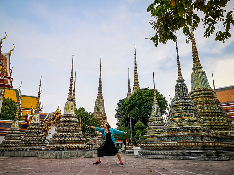 woman relaxing at Wat Phra Chetuphon (Wat Pho) temple. Bangkok. Thailand