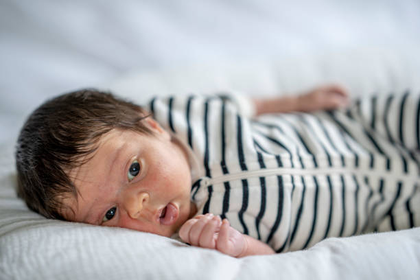 istock Newborn Laying on a Bed 1421635601