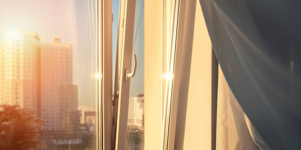 istock Open window plastic frame and wind blowing and swaying white curtain 1421635984