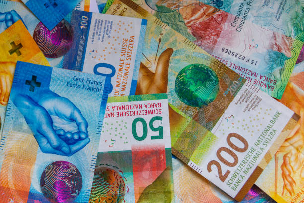 istock Background of the different swiss francs banknotes 1421637472
