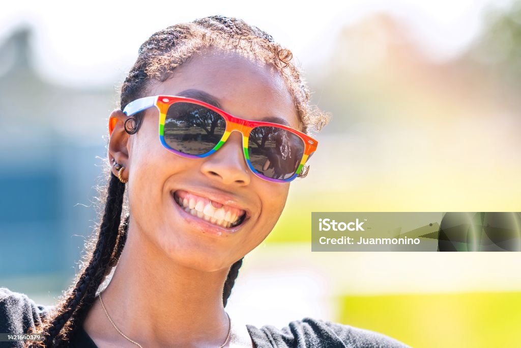 Smiling afro-latinx young woman looking at the camera Teenager Stock Photo