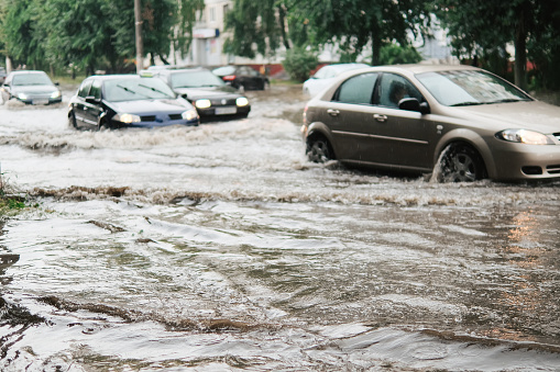 Cars on the street flooded with rain