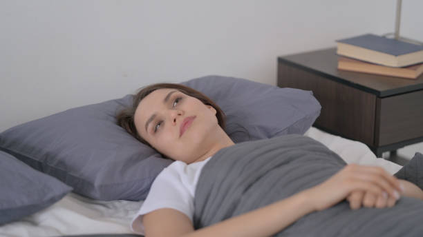 istock Woman Awake in Bed Thinking 1421646813
