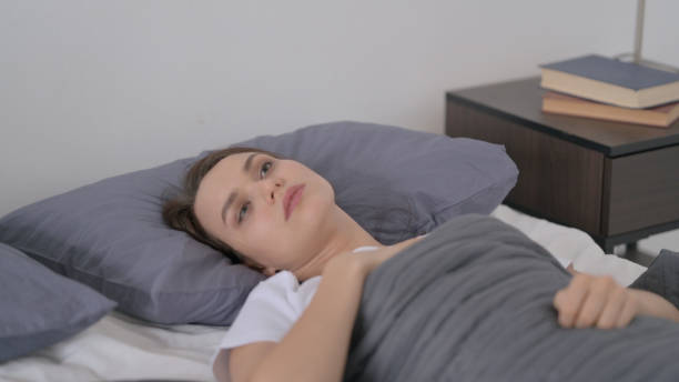 istock Woman Waking up from Nightmare in Bed 1421647001