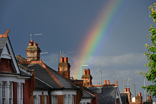 London suburban chimney pots set against a rainbow  London, UK