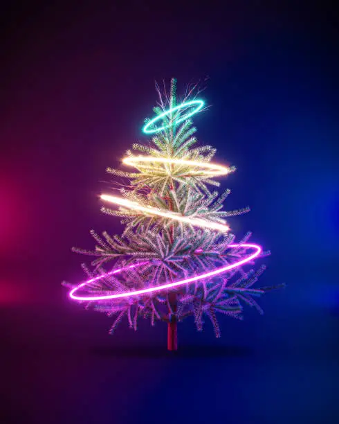 Photo of Futuristic creative cyberpunk concept of Christmas tree with neon hoops on urban dark background. New year party.