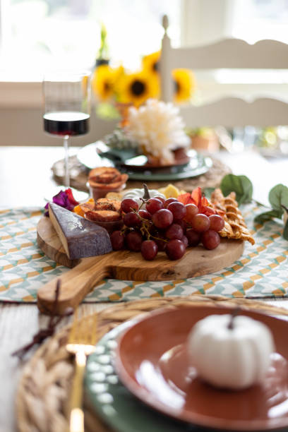 istock Charcuterie board on a dining room table styled for fall 1421648776