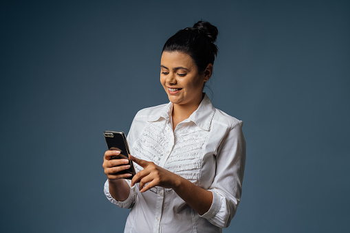 White collar female worker using smartphone