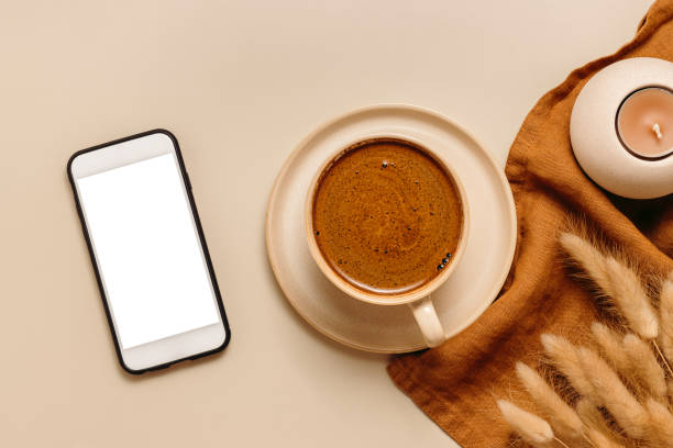istock Cup of coffee with white blank screen mobile phone with clipping path 1421650052