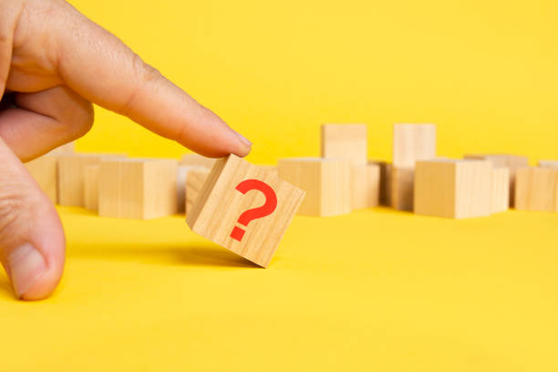 istock wooden block with question mark on yellow background 1421650275