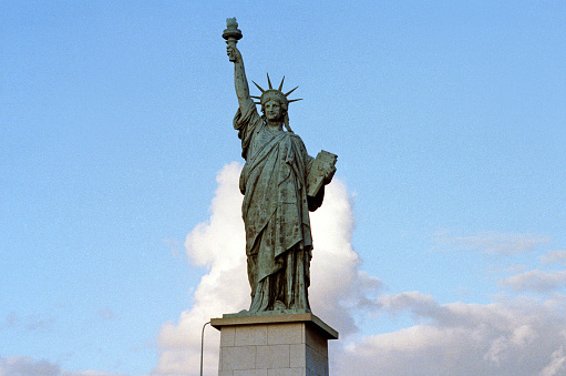 Paris, France - 1983: A vintage 1980's Fujifilm negative film scan of the replica copper green statue of liberty in Paris, France.