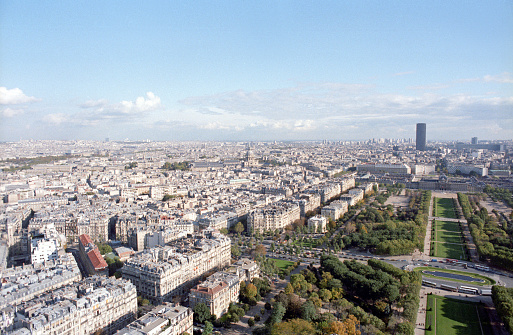 Paris, France - 1983: A vintage 1980's Fujifilm negative film scan of an aerial shot of the Paris skyline taken from the top of the Eiffel tower.