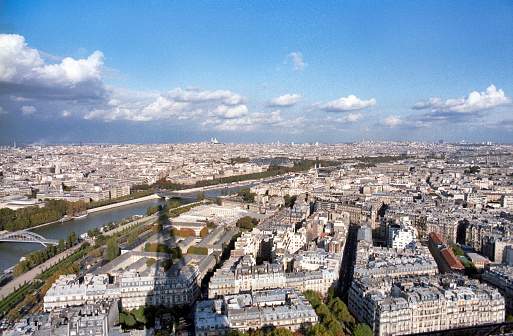 Paris, France - 1983: A vintage 1980's Fujifilm negative film scan of an aerial shot of the Paris skyline taken from the top of the Eiffel tower.
